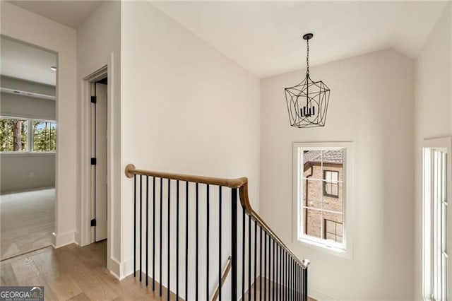 interior space featuring hardwood / wood-style floors, vaulted ceiling, and an inviting chandelier