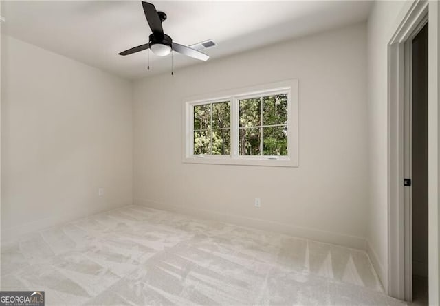 carpeted spare room with ceiling fan