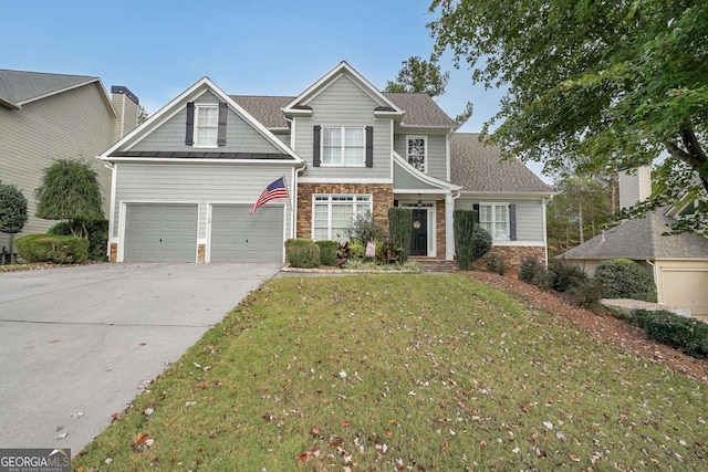 craftsman house featuring driveway, stone siding, roof with shingles, and a front yard