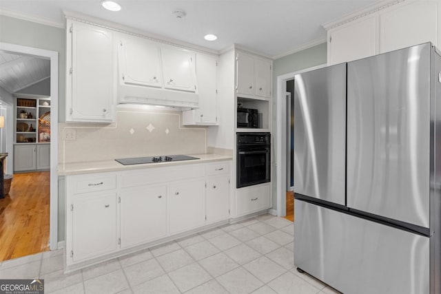 kitchen with light countertops, under cabinet range hood, black appliances, and white cabinetry