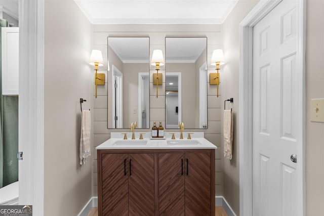 bathroom with double vanity, ornamental molding, and a sink