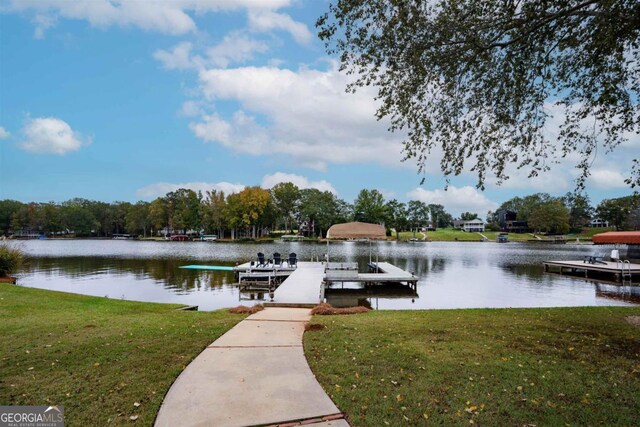 dock area featuring a water view and a yard