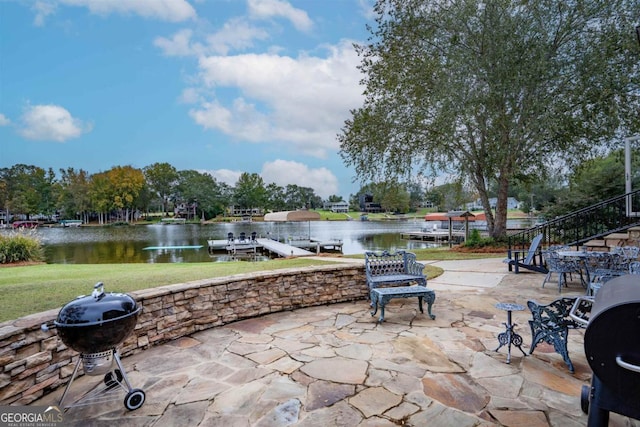 view of patio / terrace with a water view, a grill, and a floating dock