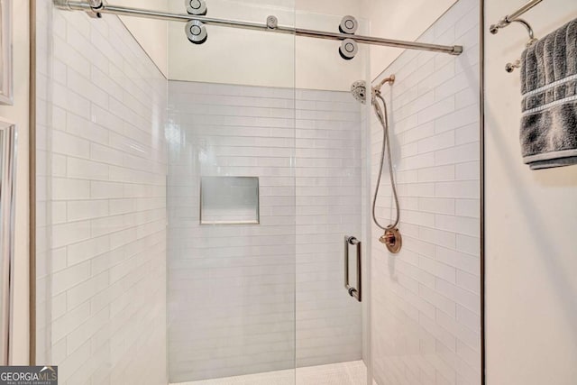 bathroom featuring a shower with door