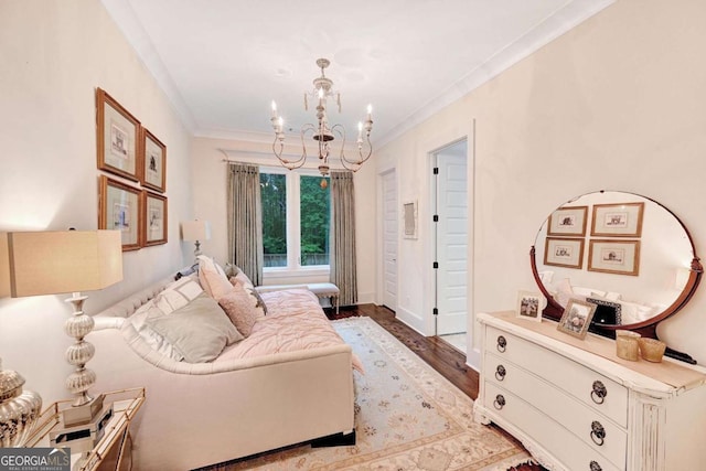 sitting room with light wood-type flooring, an inviting chandelier, and crown molding