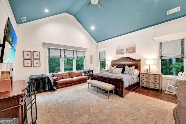 bedroom featuring hardwood / wood-style floors, ceiling fan, and high vaulted ceiling