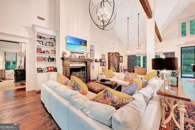 living room featuring beamed ceiling, dark hardwood / wood-style flooring, high vaulted ceiling, and a chandelier