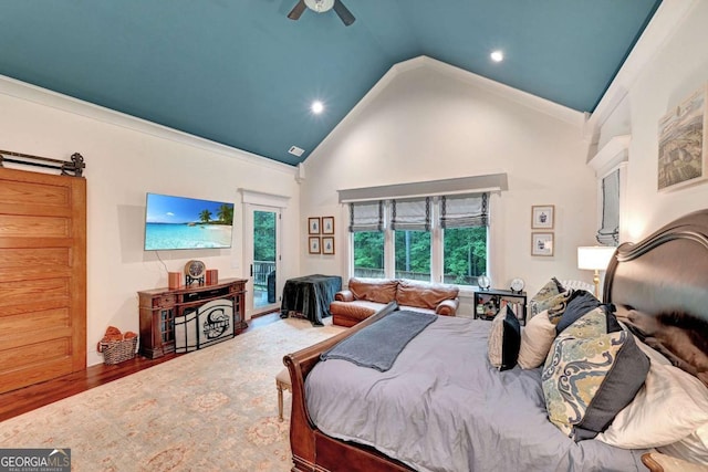 bedroom with hardwood / wood-style flooring, ceiling fan, ornamental molding, and high vaulted ceiling