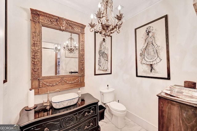 bathroom with vanity, toilet, and crown molding