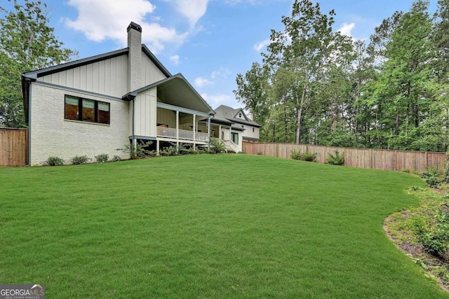 rear view of property featuring a lawn