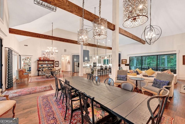 dining space featuring a chandelier, hardwood / wood-style floors, and high vaulted ceiling