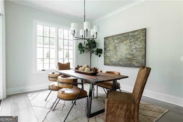 dining area featuring ceiling fan with notable chandelier, ornamental molding, and light hardwood / wood-style flooring