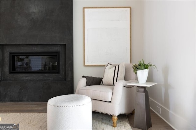 living room featuring beamed ceiling and hardwood / wood-style floors