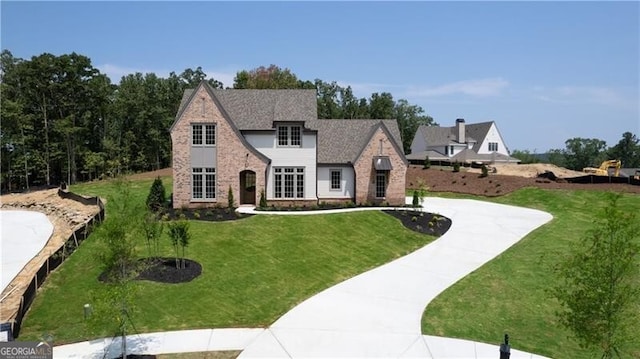 tudor-style house with a front lawn