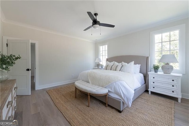 bedroom featuring ceiling fan, light hardwood / wood-style floors, and ornamental molding