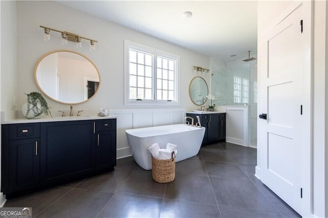 bathroom featuring plus walk in shower, vanity, and tile patterned floors