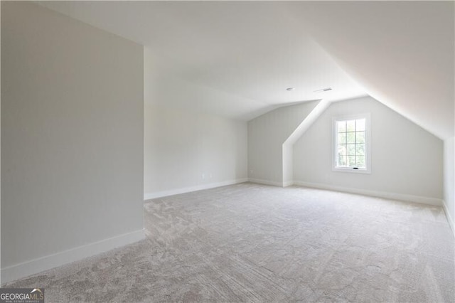 bonus room featuring light colored carpet and lofted ceiling