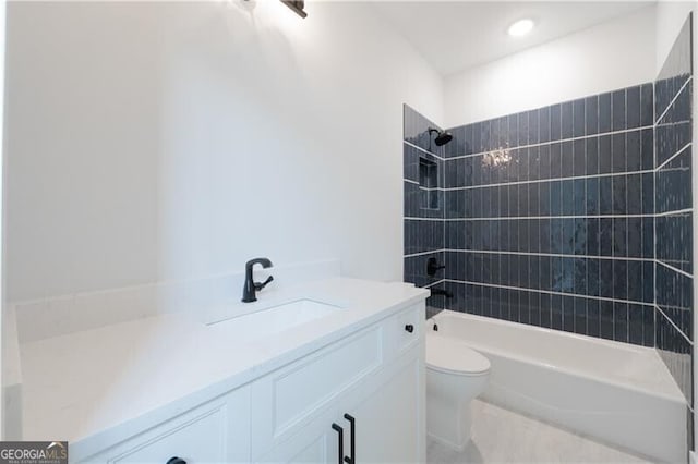 full bathroom with toilet, vanity, and tiled shower / bath