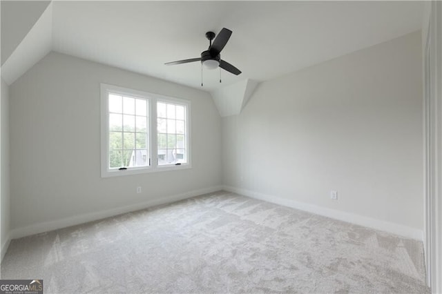 additional living space featuring ceiling fan, light colored carpet, and lofted ceiling