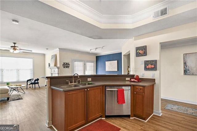 kitchen with crown molding, plenty of natural light, dishwasher, and sink