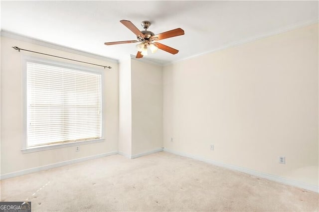 unfurnished room featuring light colored carpet, ornamental molding, and ceiling fan