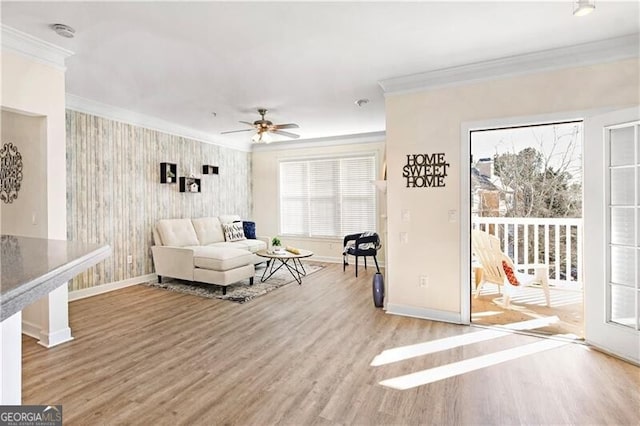 living room with crown molding, hardwood / wood-style floors, and ceiling fan