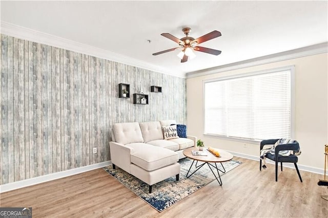 living room with hardwood / wood-style floors, crown molding, and ceiling fan