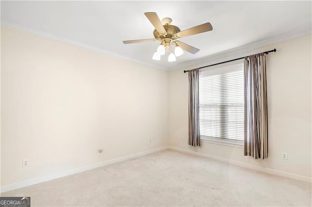 carpeted spare room featuring crown molding and ceiling fan