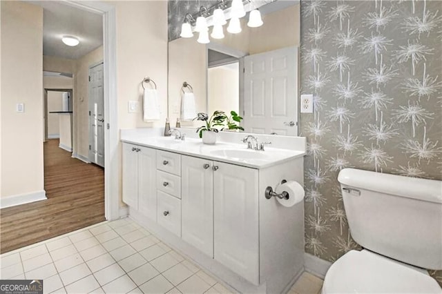 bathroom featuring vanity, tile patterned flooring, and toilet