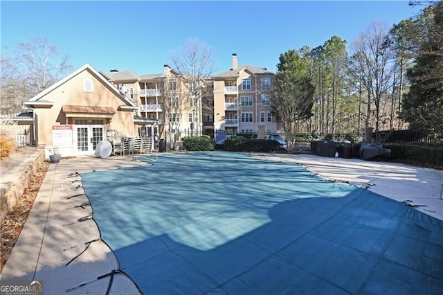 view of pool featuring french doors and a patio area