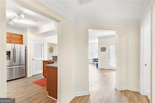 hall with crown molding and light hardwood / wood-style floors