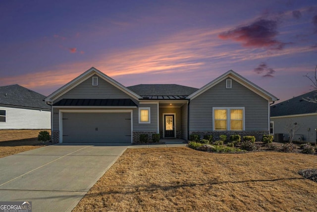 view of front of property featuring a garage and central AC unit