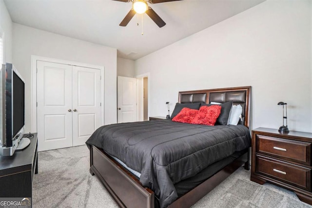 carpeted bedroom with ceiling fan and a closet