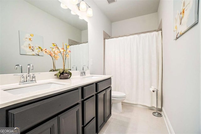 bathroom featuring tile patterned floors, walk in shower, vanity, and toilet