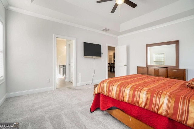 bedroom featuring carpet, a raised ceiling, ceiling fan, and ornamental molding