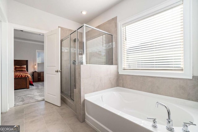 bathroom featuring tile patterned floors and shower with separate bathtub