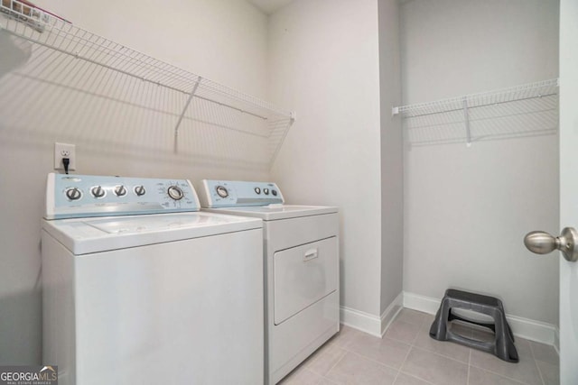 washroom featuring light tile patterned flooring and separate washer and dryer