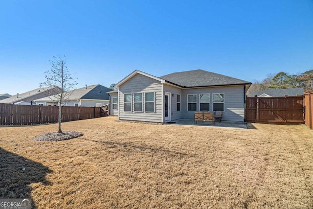 back of property with a lawn and a patio