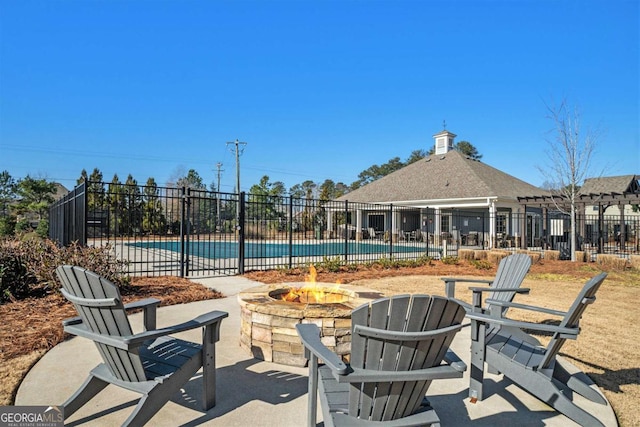 view of patio featuring a community pool and a fire pit