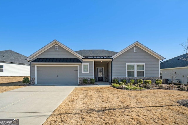 view of front of property with central AC unit and a garage