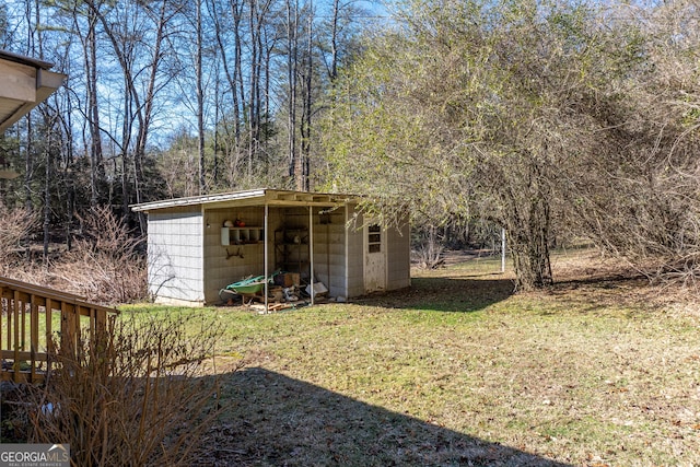 view of outbuilding with a yard