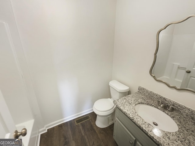 bathroom featuring hardwood / wood-style flooring, vanity, and toilet