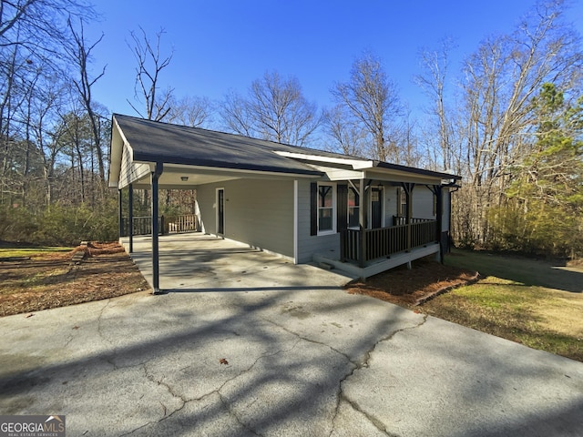 view of front of house featuring covered porch and a carport