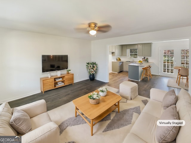 living room with ceiling fan, dark wood-type flooring, and sink