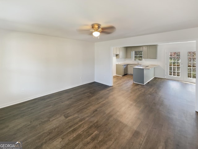 unfurnished living room with ceiling fan and dark hardwood / wood-style flooring