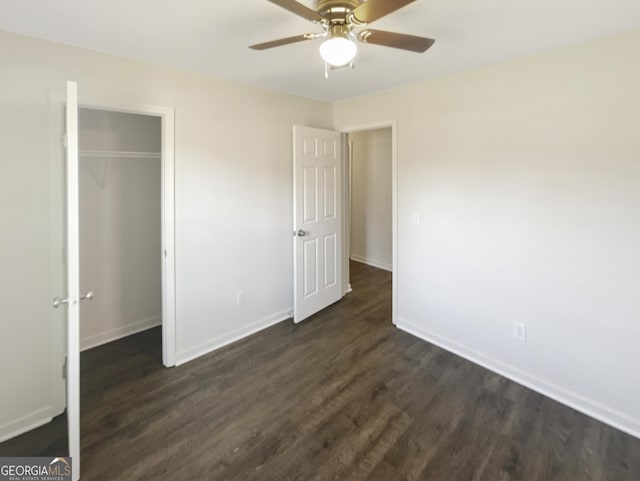 unfurnished bedroom featuring ceiling fan, dark wood-type flooring, and a closet