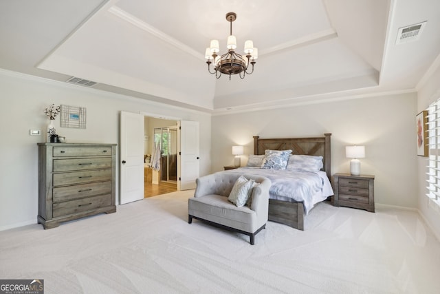 bedroom featuring a tray ceiling, multiple windows, and an inviting chandelier