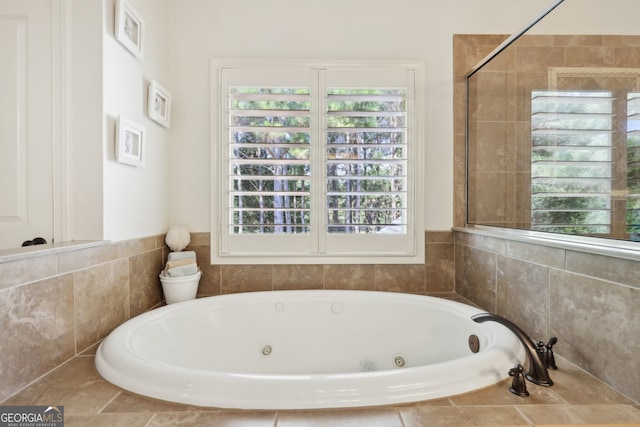 bathroom with a relaxing tiled tub