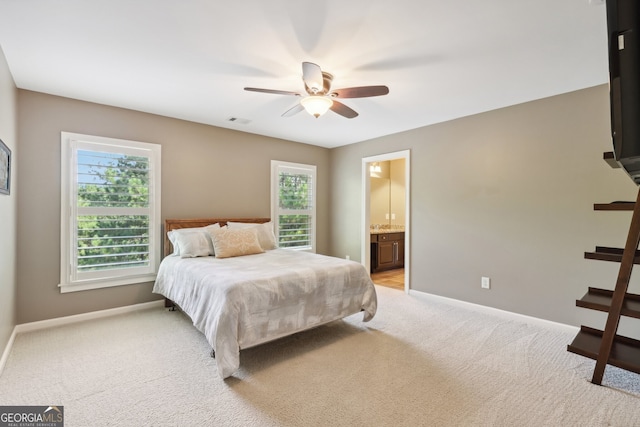 carpeted bedroom with ceiling fan and ensuite bathroom