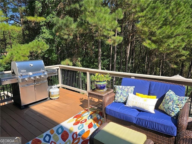 deck featuring an outdoor hangout area and grilling area